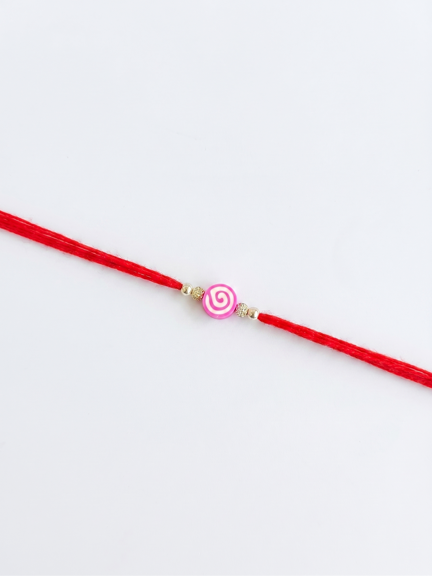 pink swirl lollipop charm sparkle rakhi