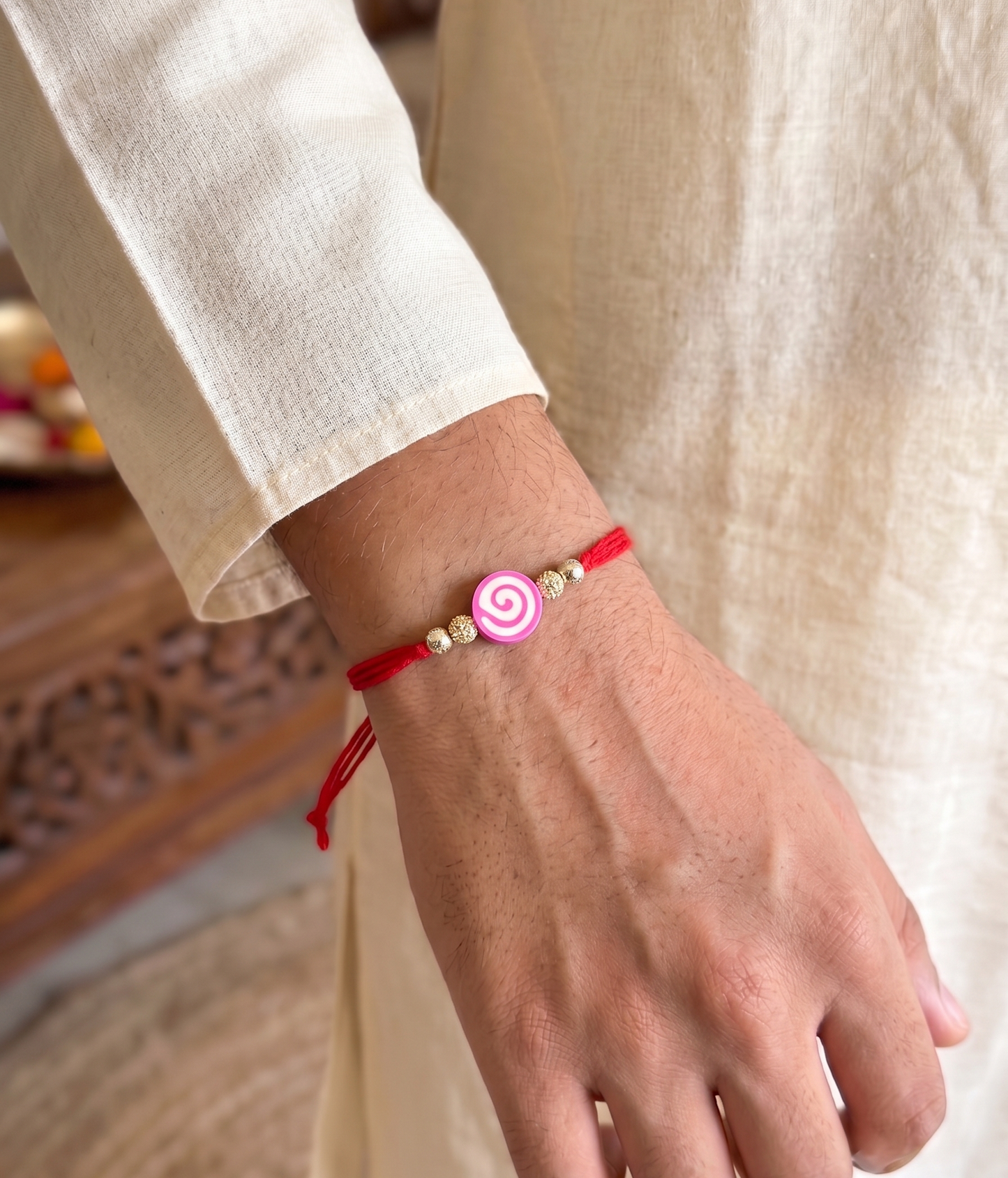 pink swirl lollipop charm sparkle rakhi