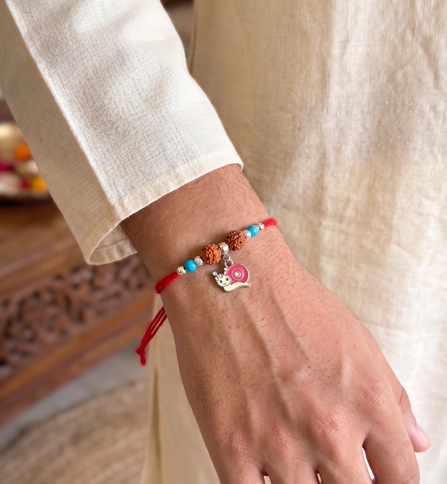 whimsical snail rudraksha silver rakhi