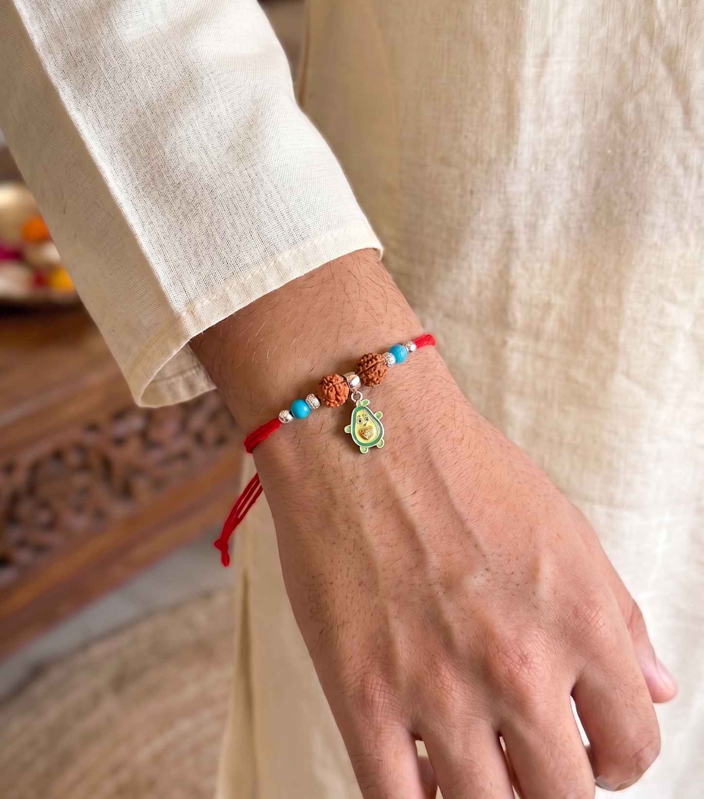 playful avocado rudraksha silver rakhi