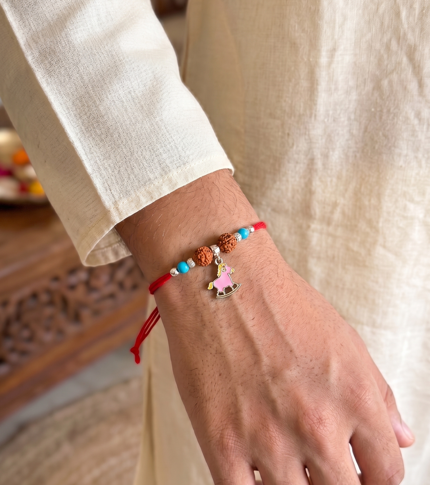 playful rocking horse rudraksha silver rakhi