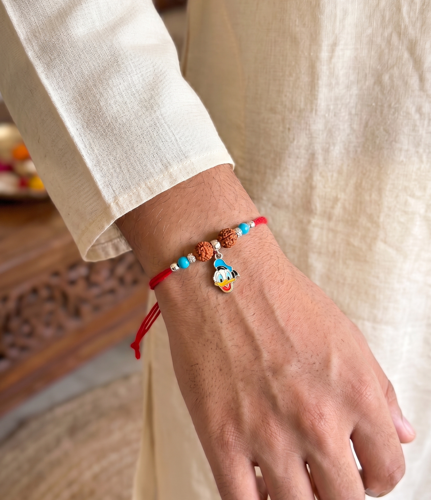 playful donald duck rudraksha silver rakhi
