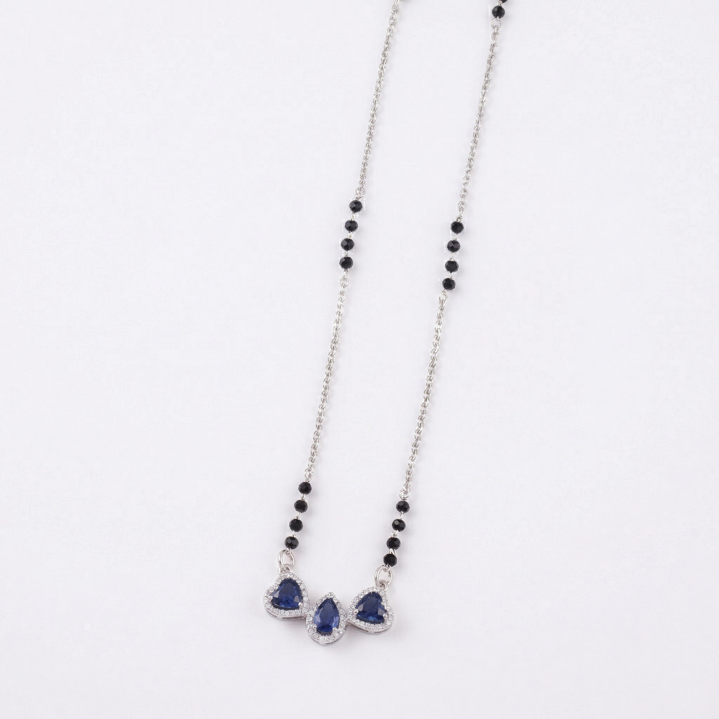 elegant silver-tone mangalsutra with black beads and triple teardrop stone pendant