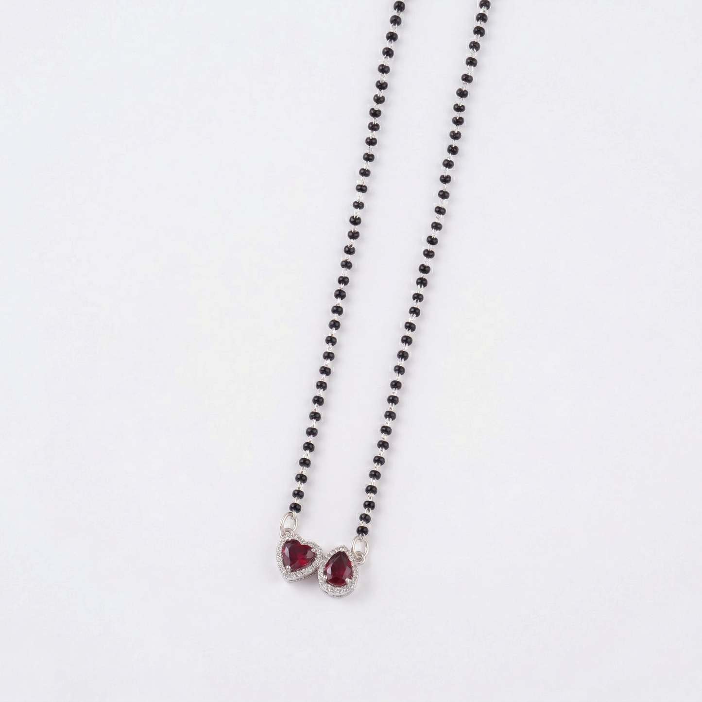 elegant silver-tone mangalsutra with black beads and dual heart & teardrop halo pendants