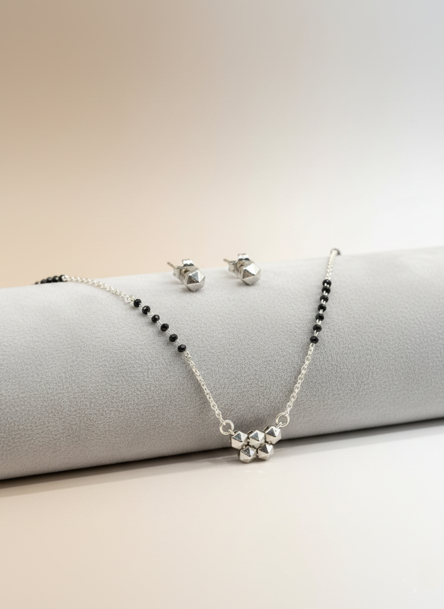 elegant silver-tone geometric studded mangalsutra with black beaded chain & matching earrings
