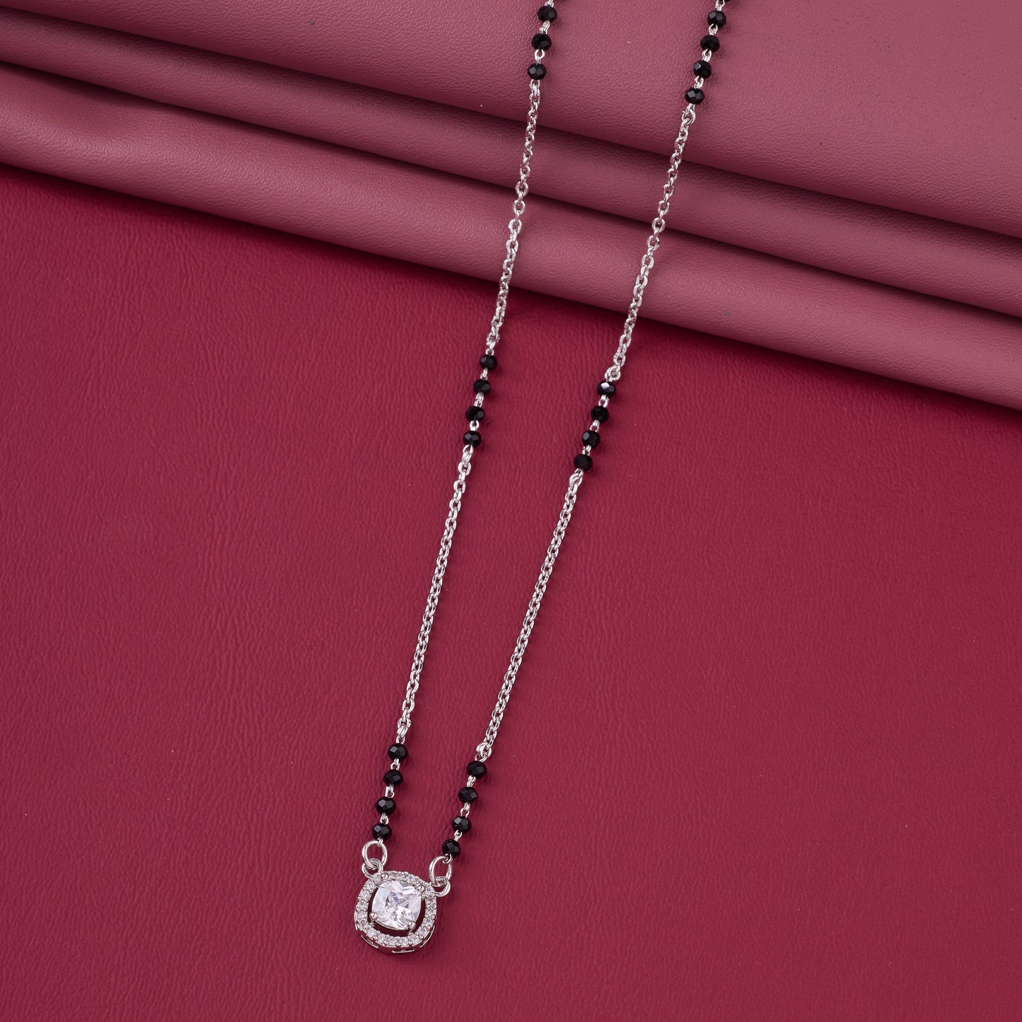 graceful silver-tone mangalsutra with black beads and sparkling cushion-cut pendant