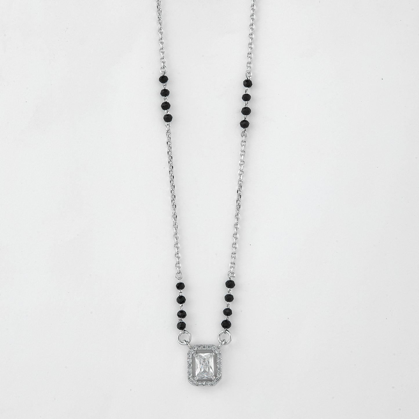 elegant silver-tone mangalsutra with black beads and sparkling emerald-cut pendant