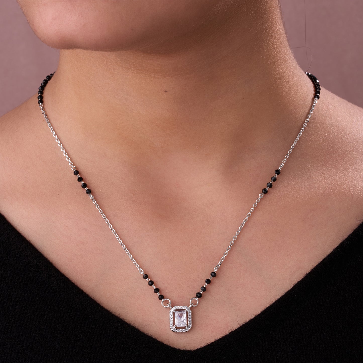 elegant silver-tone mangalsutra with black beads and sparkling emerald-cut pendant