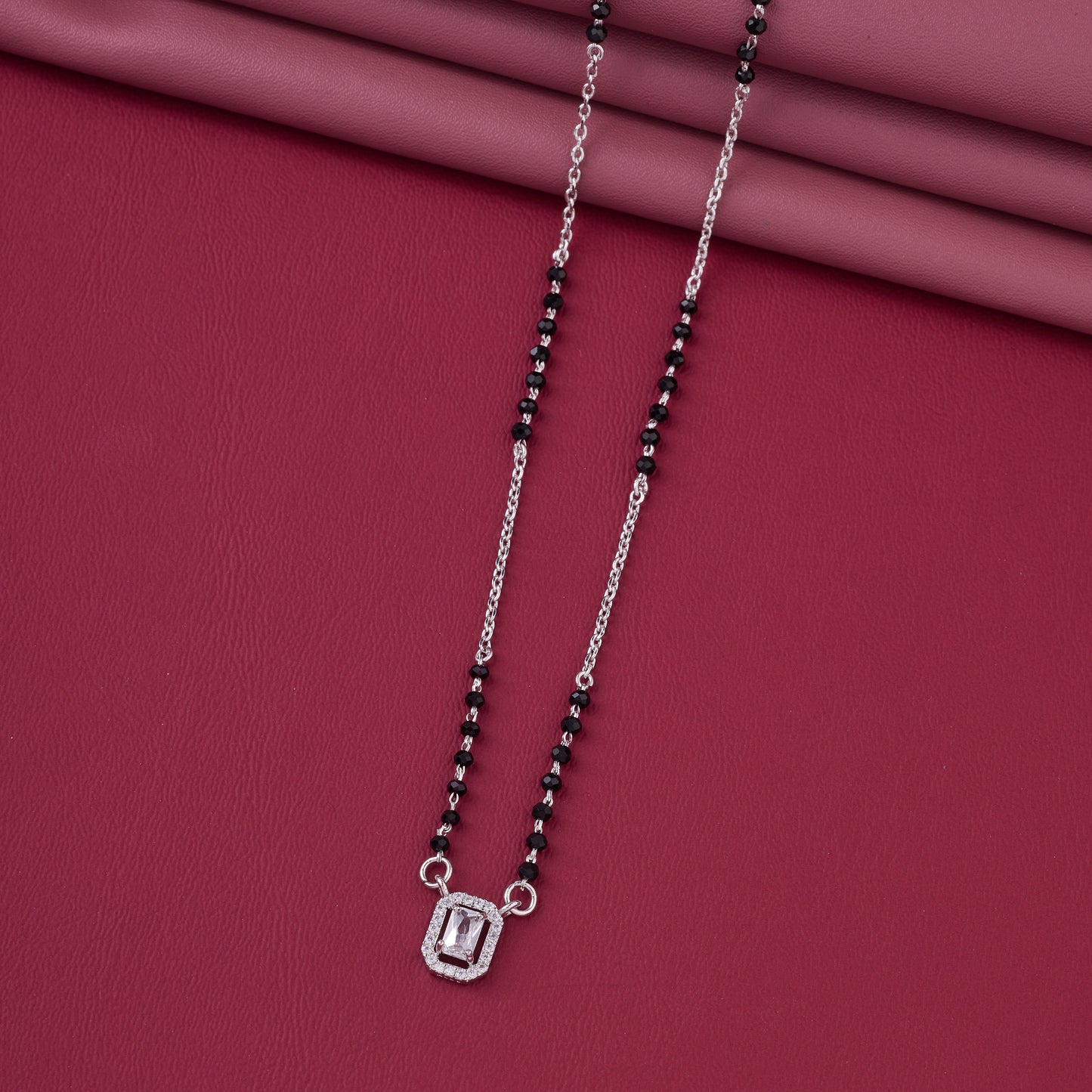 stylish silver-tone mangalsutra with black beads and sparkling rectangular halo pendant