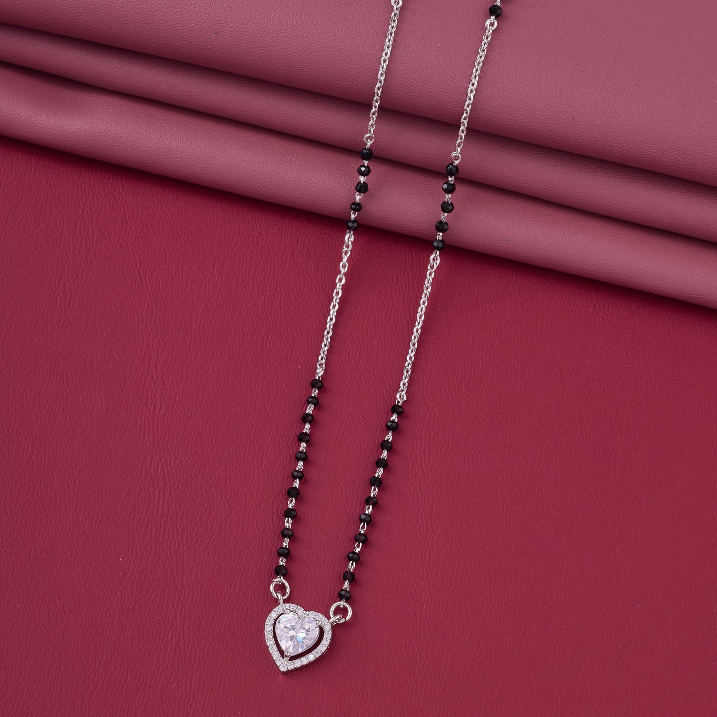elegant silver-tone mangalsutra with black beads and sparkling heart-shaped halo pendant