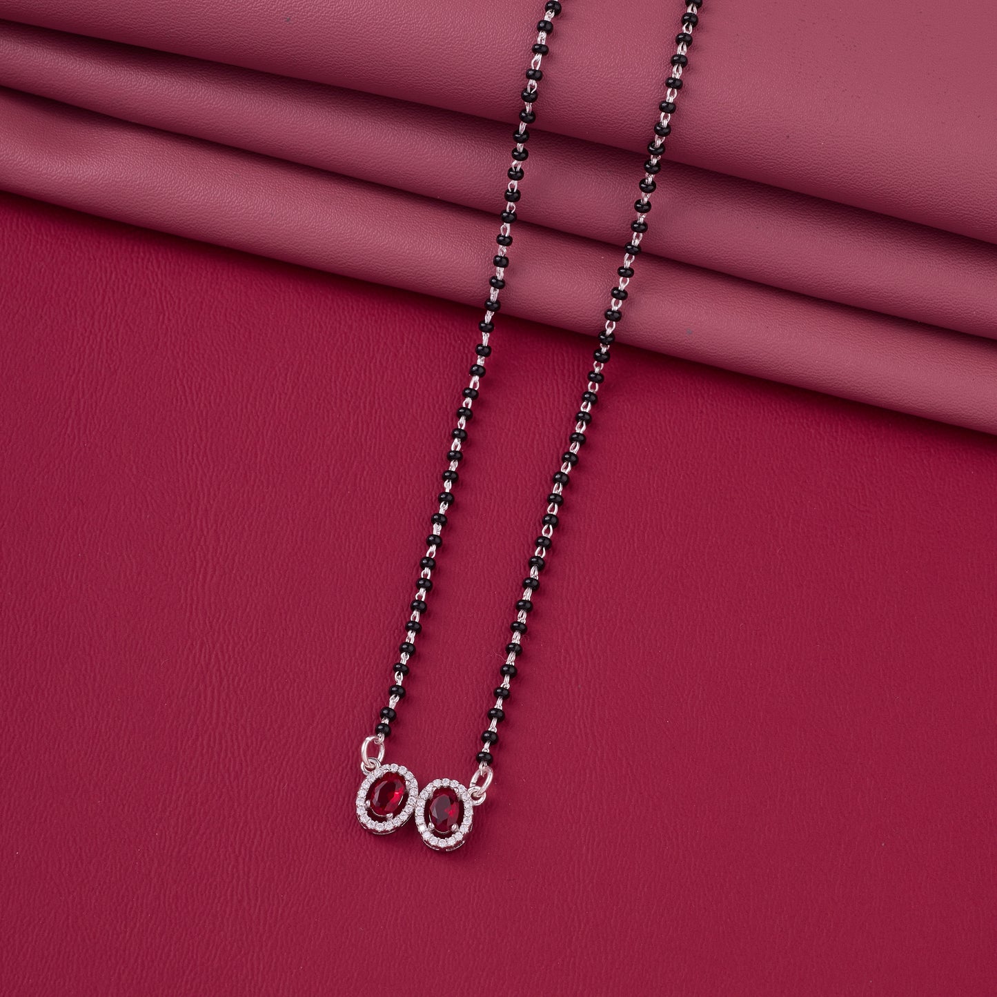 elegant silver-tone mangalsutra with black beads and dual oval halo pendants