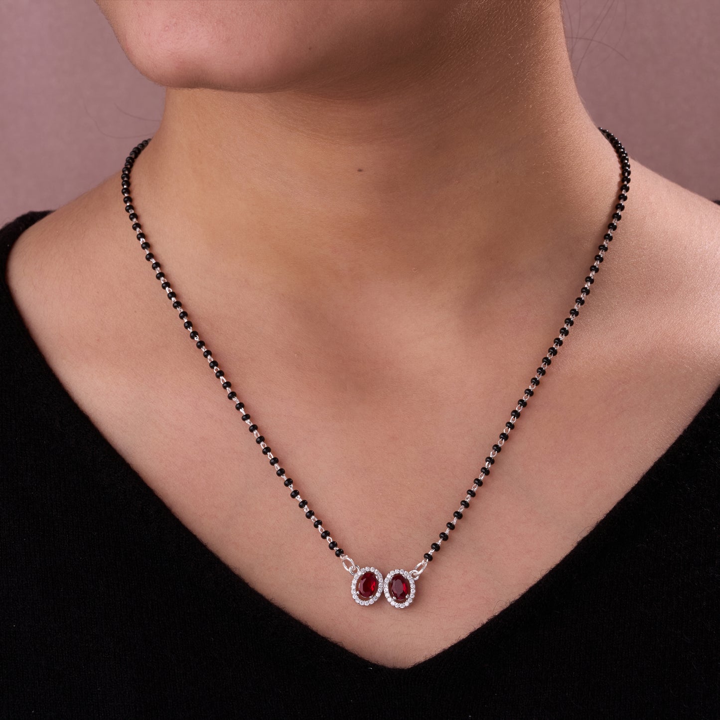 elegant silver-tone mangalsutra with black beads and dual oval halo pendants