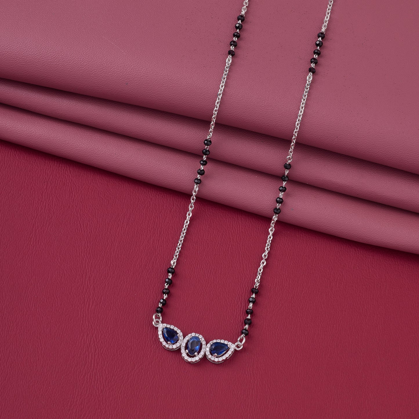 elegant silver-tone mangalsutra with black beads and triple blue teardrop halo pendant