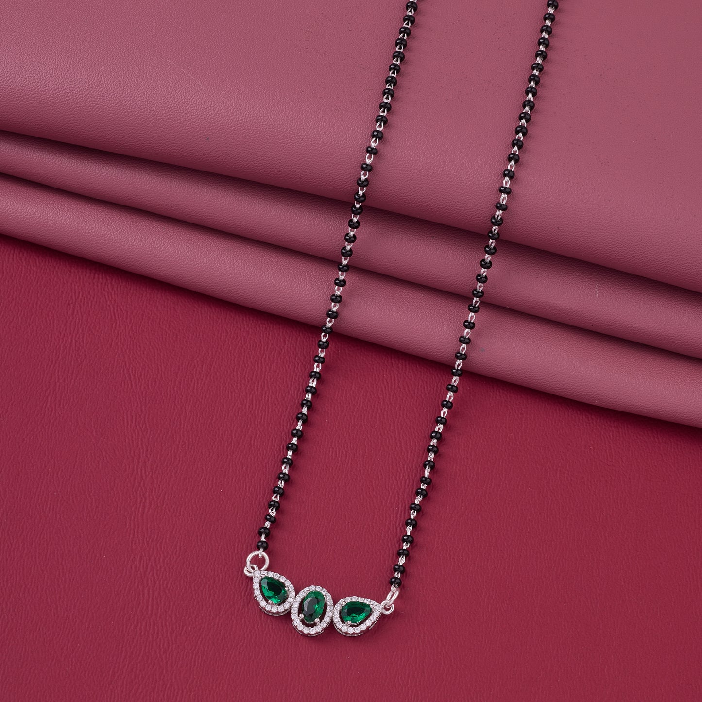 elegant silver-tone mangalsutra with black beads and triple blue teardrop halo pendant