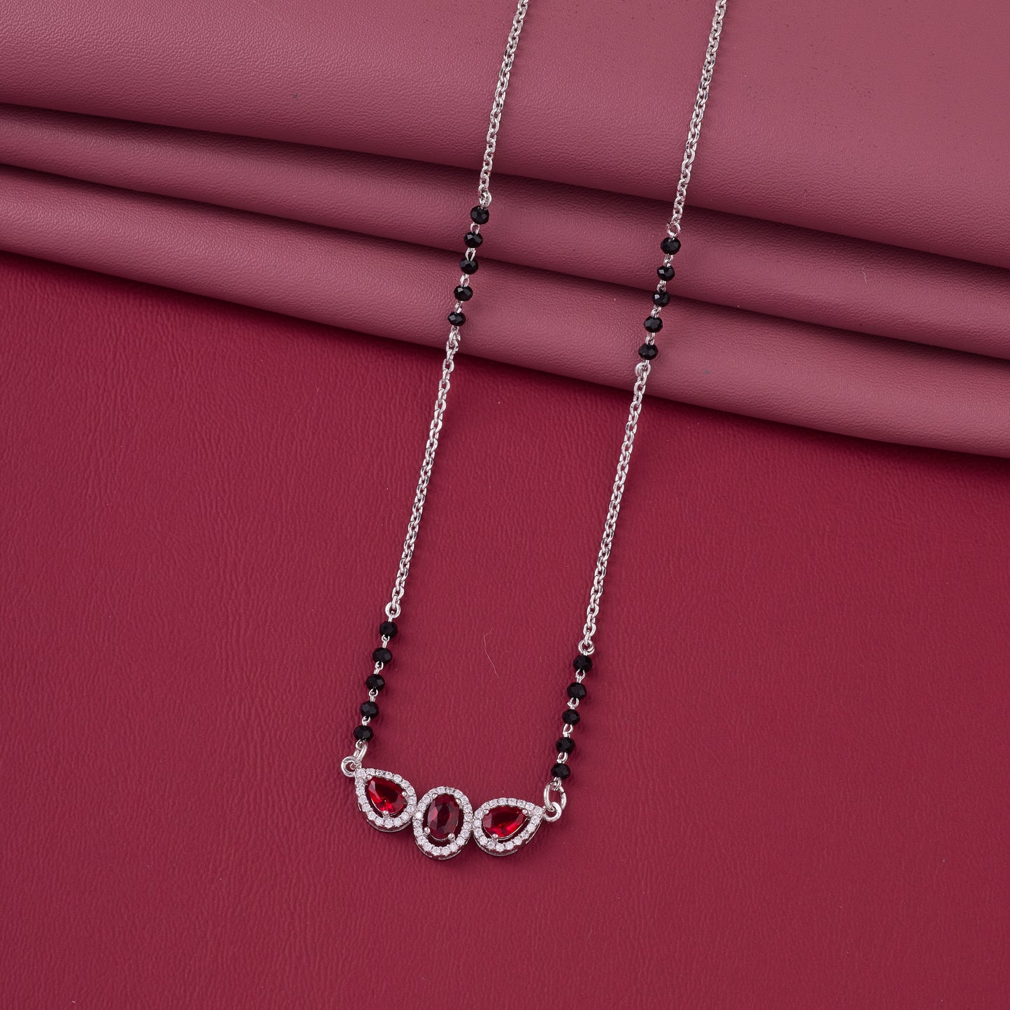 elegant silver-tone mangalsutra with black beads and triple blue teardrop halo pendant