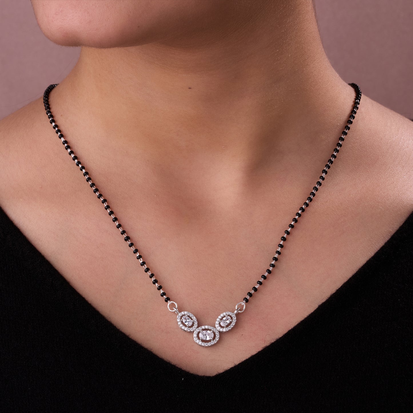 elegant silver-tone mangalsutra with black beads and triple oval crystal halo pendant