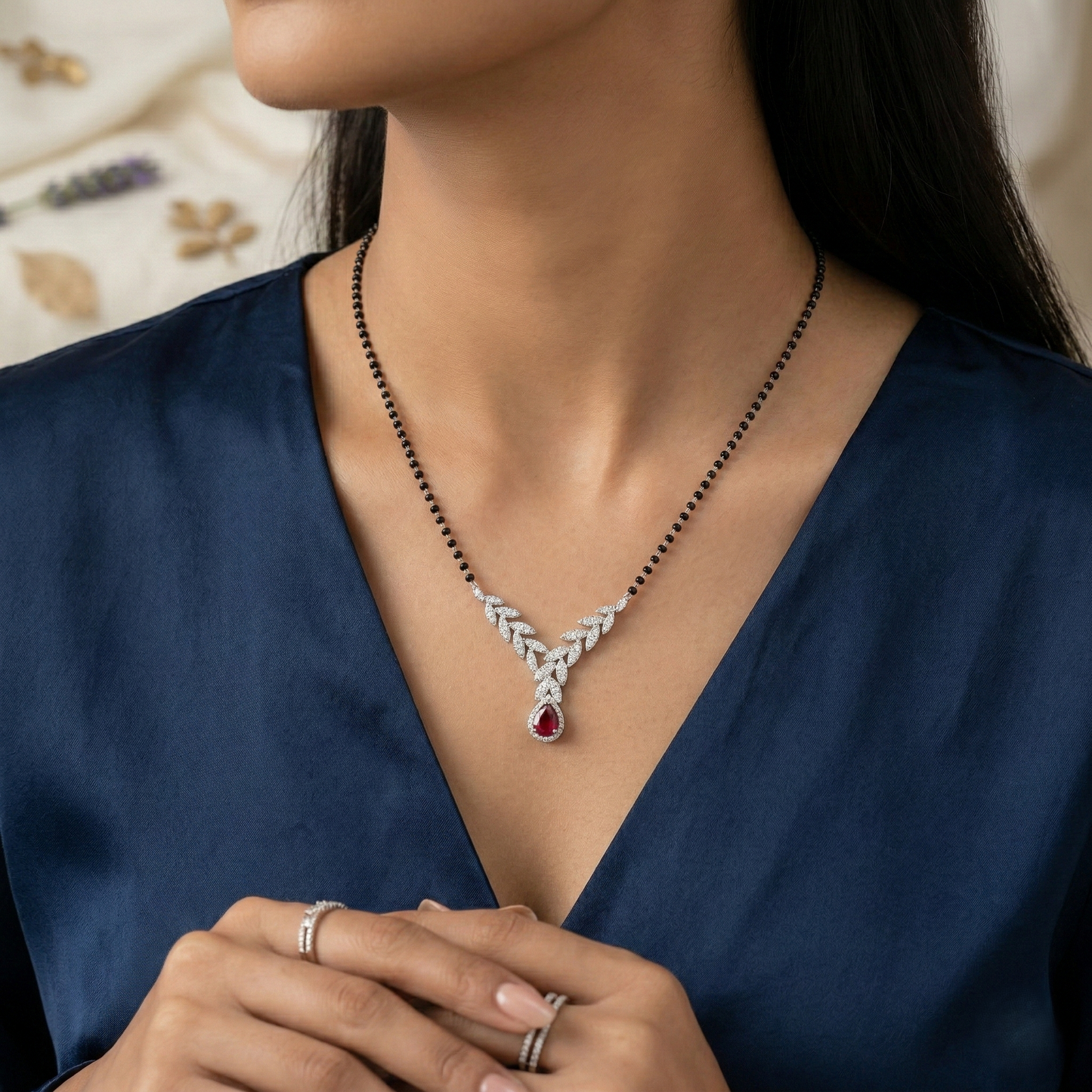 elegant silver-tone leaf design mangalsutra with green teardrop crystal and black beaded chain